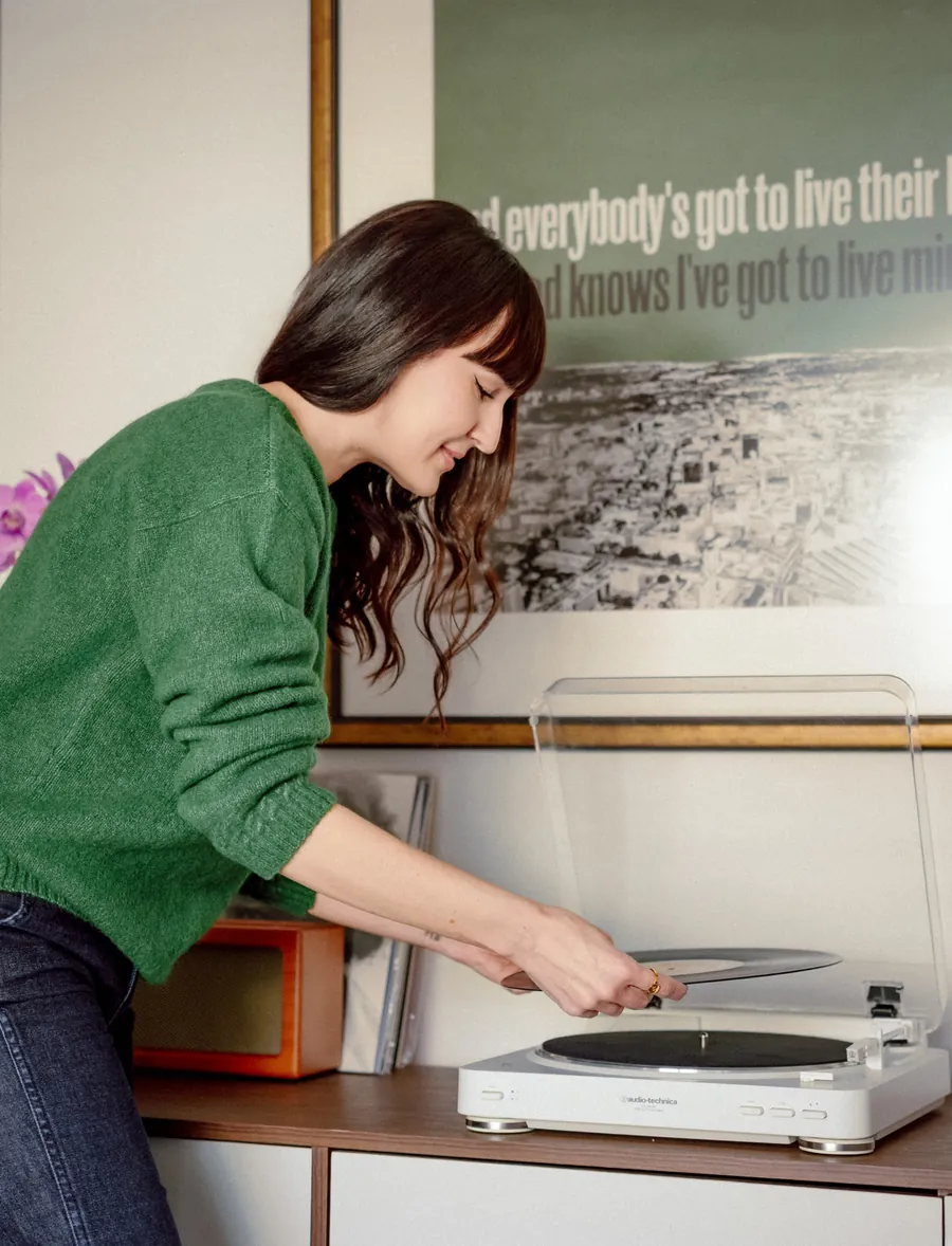 Dr. Ileana Hernandez placing a vinyl record on a turntable