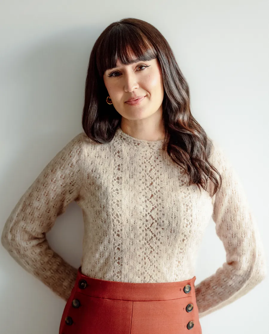 Dr. Ileana Hernandez smiling, standing with her hands behind her back
